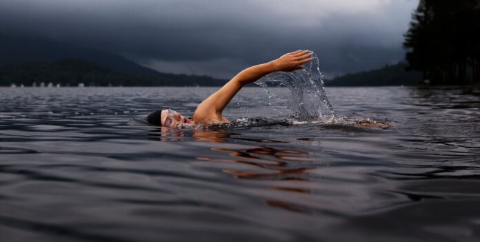 Photo by Todd Quackenbush man swimming on body of water