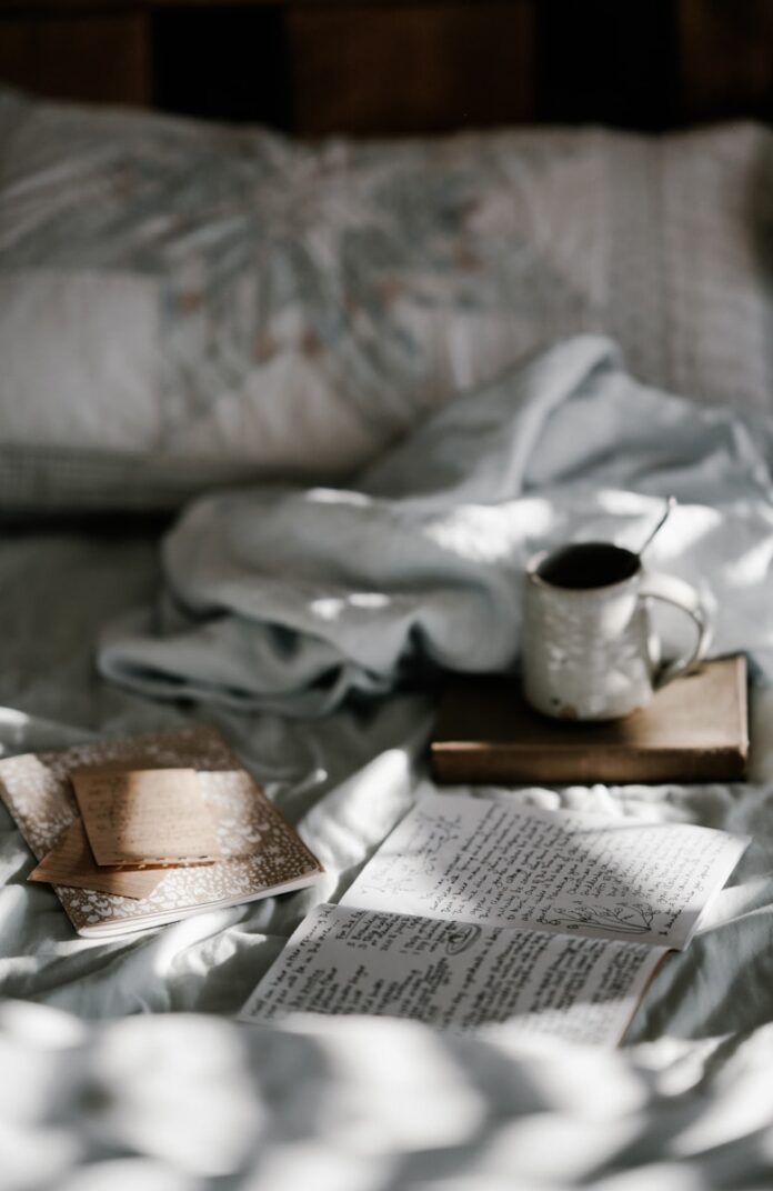 Photo by Annie Spratt coffee mug on a brown wooden coaster near white blanket